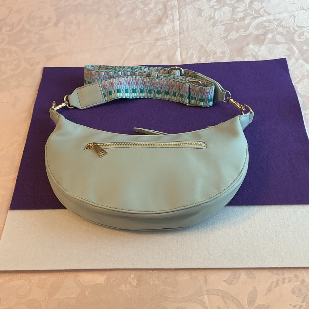 NWOT LeMiel Pale Blue Half Circle Shaped Crossbody Bag w/Guitar Style Strap.